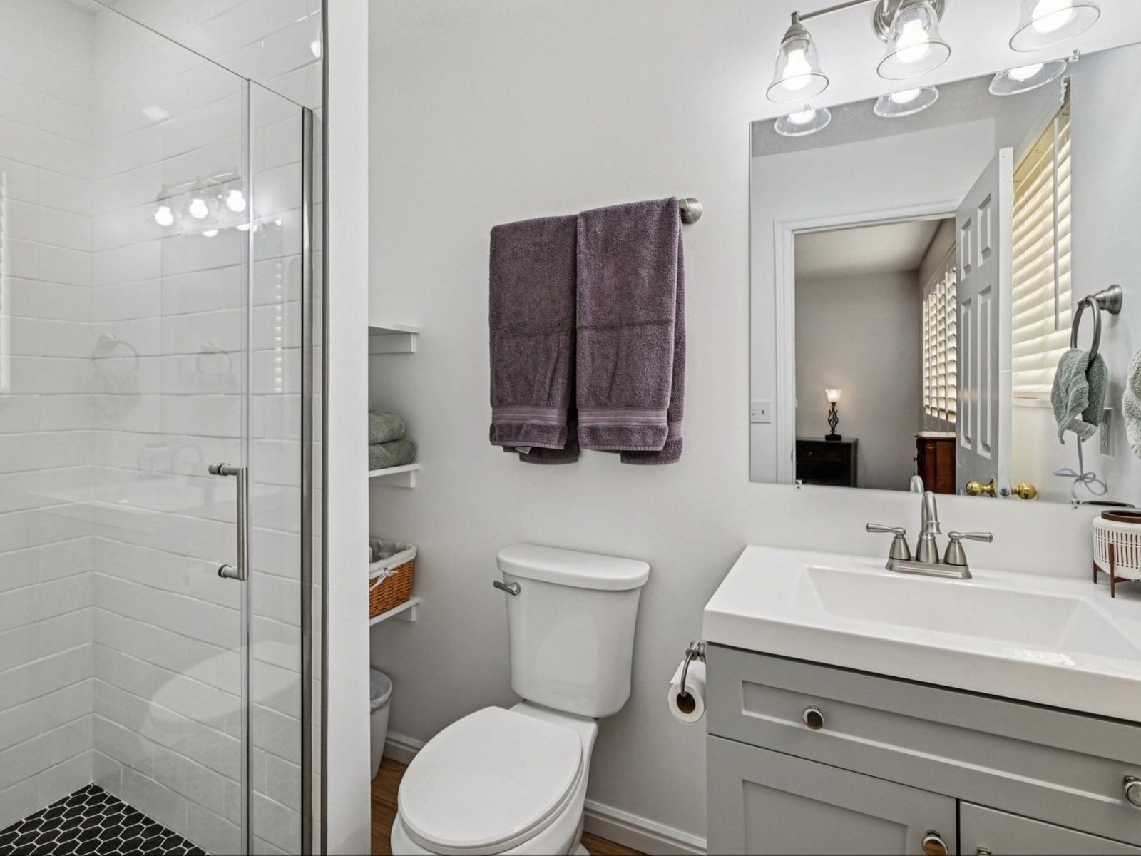 Rebuilt and tiled, with a glass panel instead of a curtain.