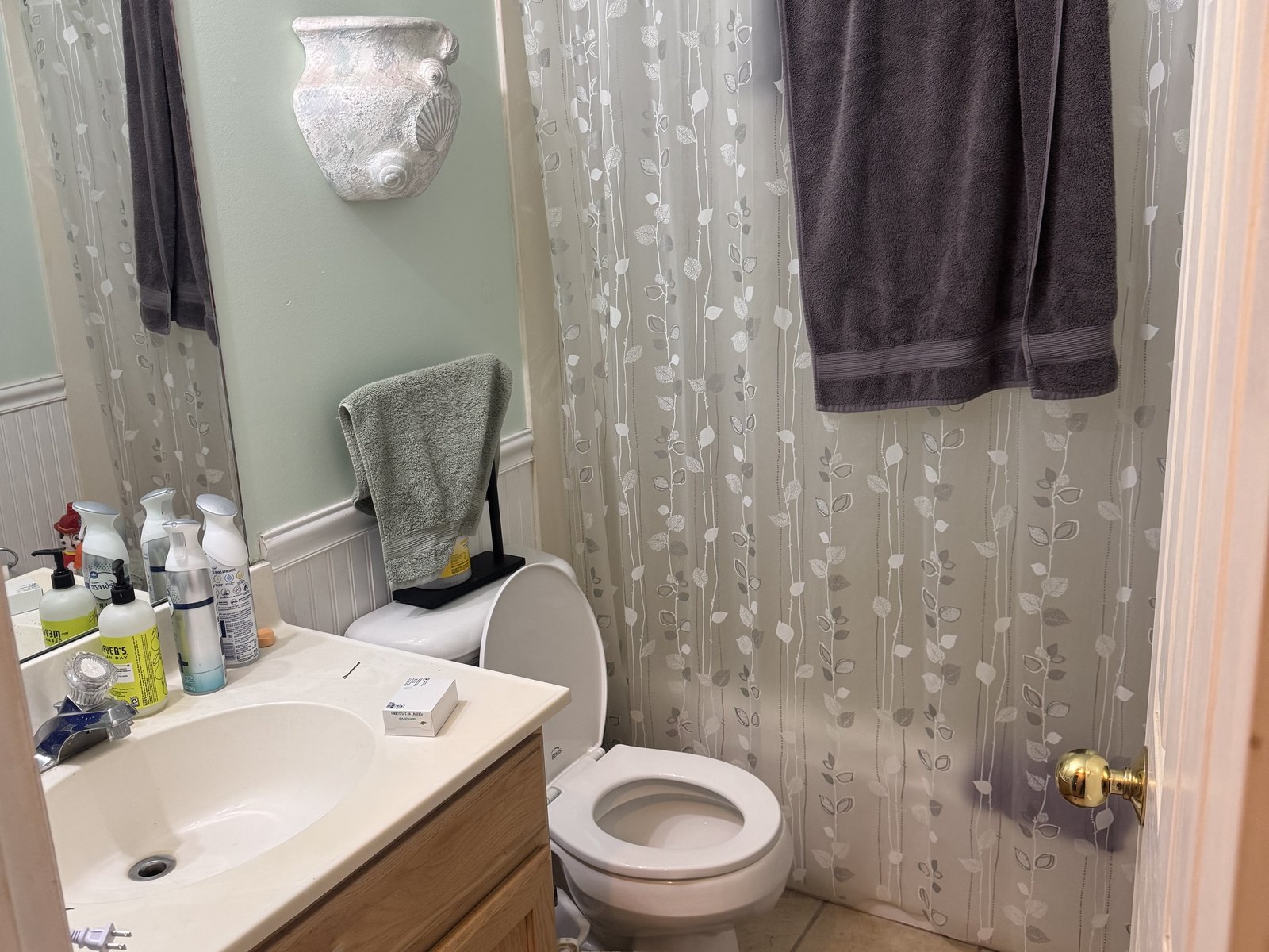 The main bathroom was sound but dated. Original vanity, original surround.